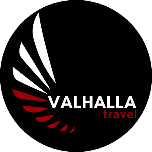 Valhalla Travel logo in a 500px black circle with red and white viking feathers and Valhalla Travel written in white and red.