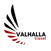 Valhalla Travel logo in a 500px white circle with red and black viking feathers and Valhalla Travel written in black and red.