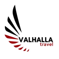 Valhalla Travel logo in a 500px white circle with red and black viking feathers and Valhalla Travel written in black and red.